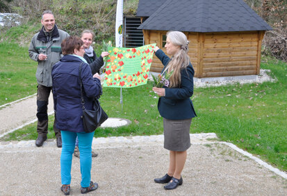Vertreter der Grundschule Großhartau übergeben Frau Anke Findeisen (Forstbezirk Neustadt, im Bild rechts), ein Plakat.