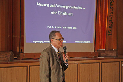 Prof. Dr. Dr. habil. Bues bei seinem Vortrag vor der Projektionswand.